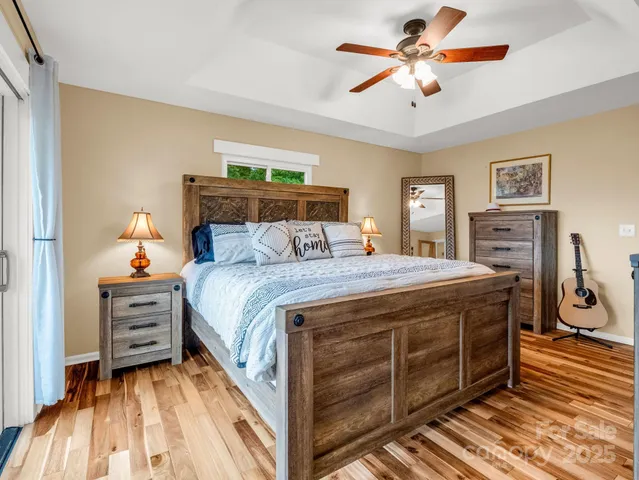 a bedroom with a bed and a chandelier