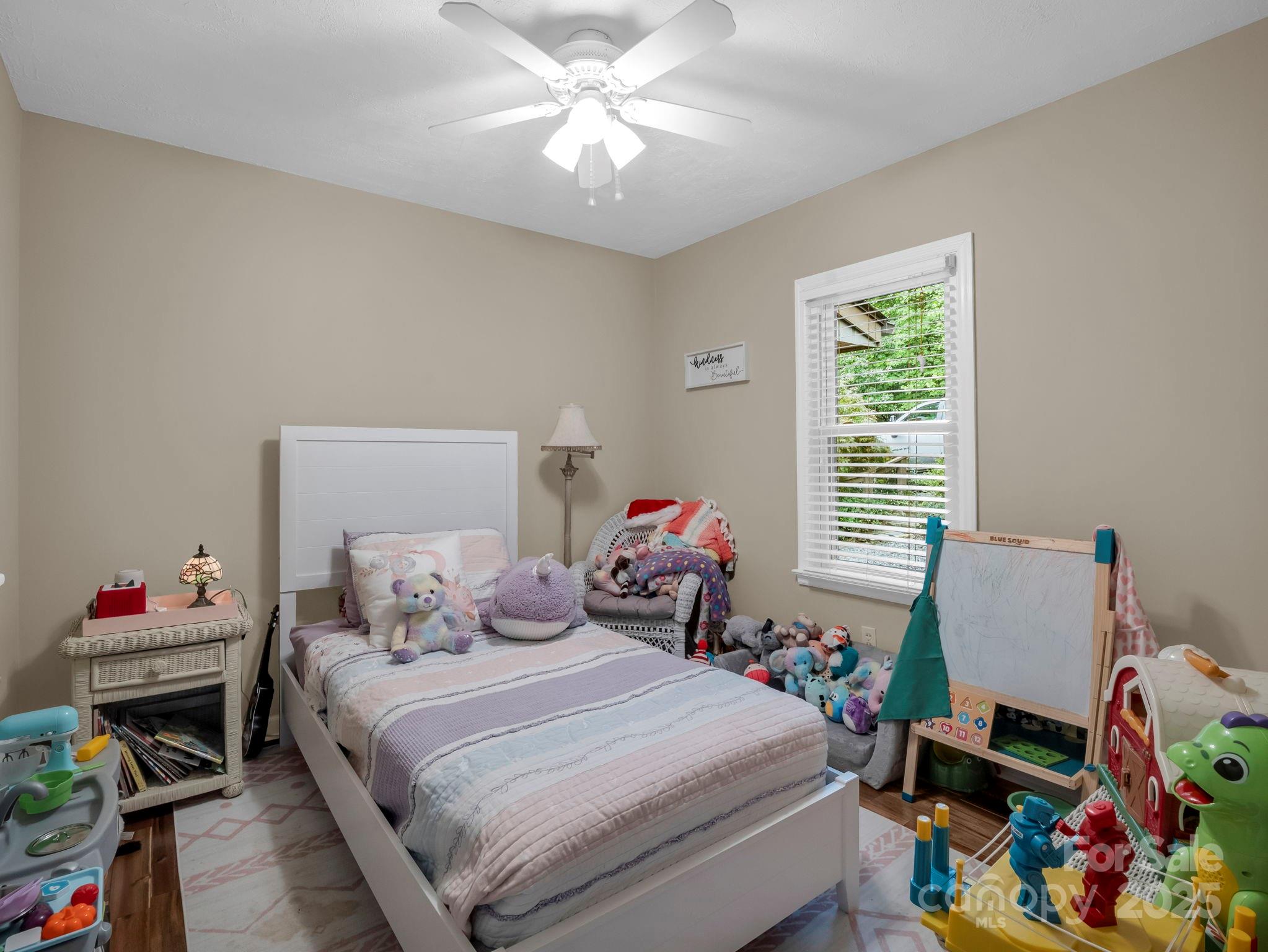 315 Thomas A Edison Rd Lake Lake Lure, NC 28746 - Photo 30 of 47 a bedroom with a bed and a chandelier