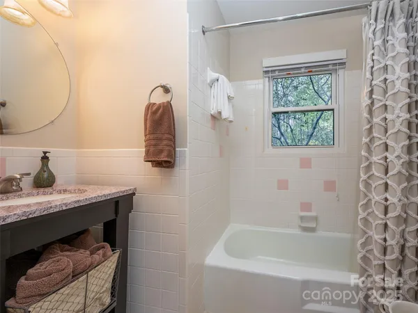 a bathroom with a granite countertop sink a toilet and shower