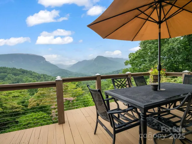 a view of balcony with furniture and umbrella