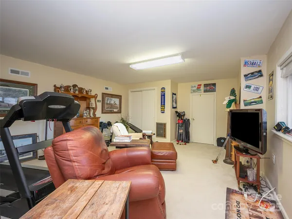 a living room with furniture a flat screen tv and a window