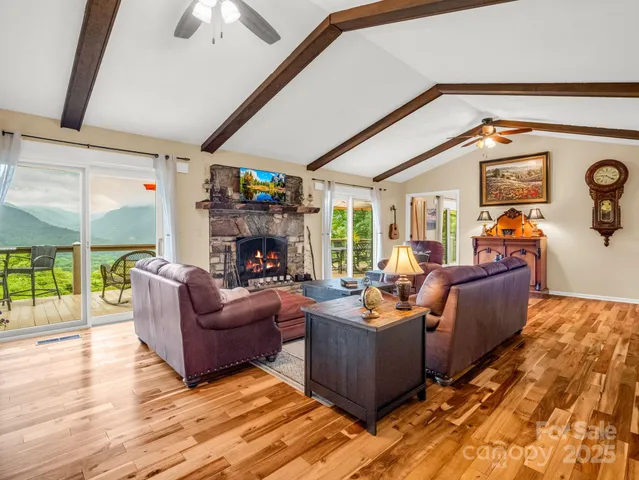 a living room with fireplace furniture and a flat screen tv