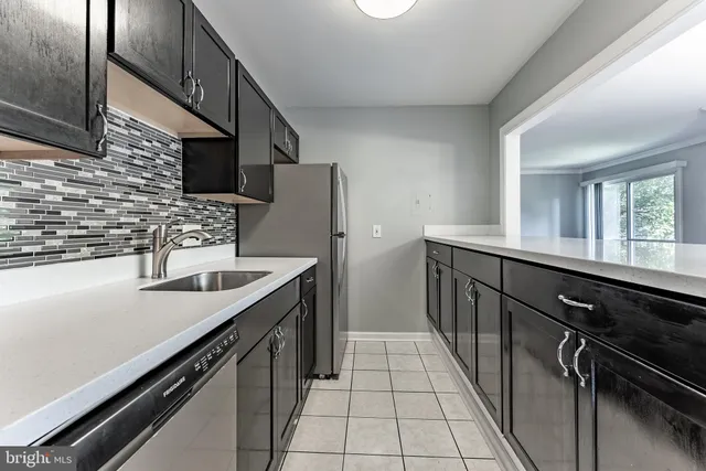 a kitchen with stainless steel appliances a sink stove and cabinets