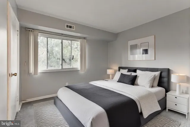 a bedroom with bed and window