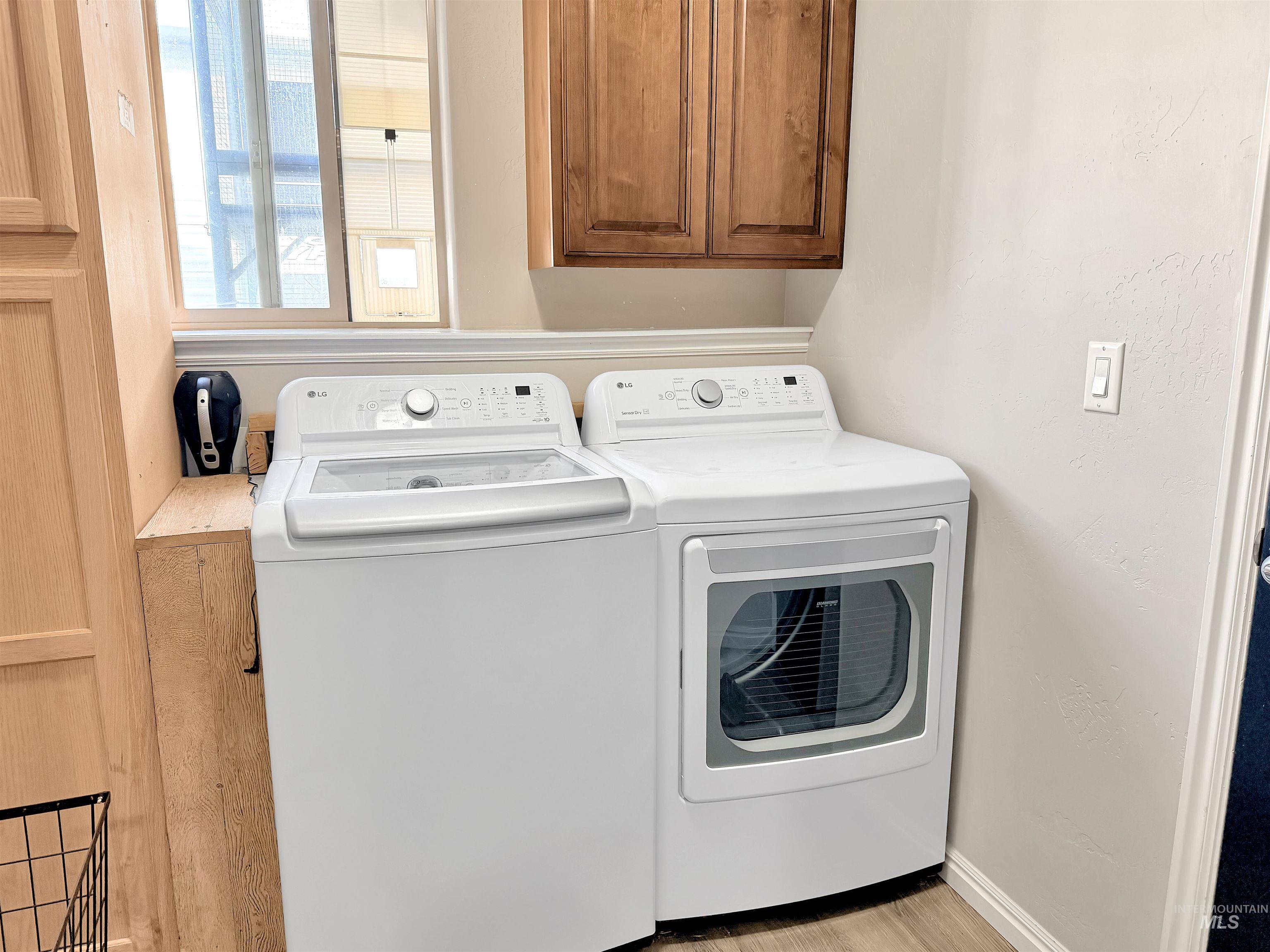2407 Forge Street Twin Falls, ID 83301 - Photo 12 of 20 Laundry room with cabinet space and washer and clothes dryer