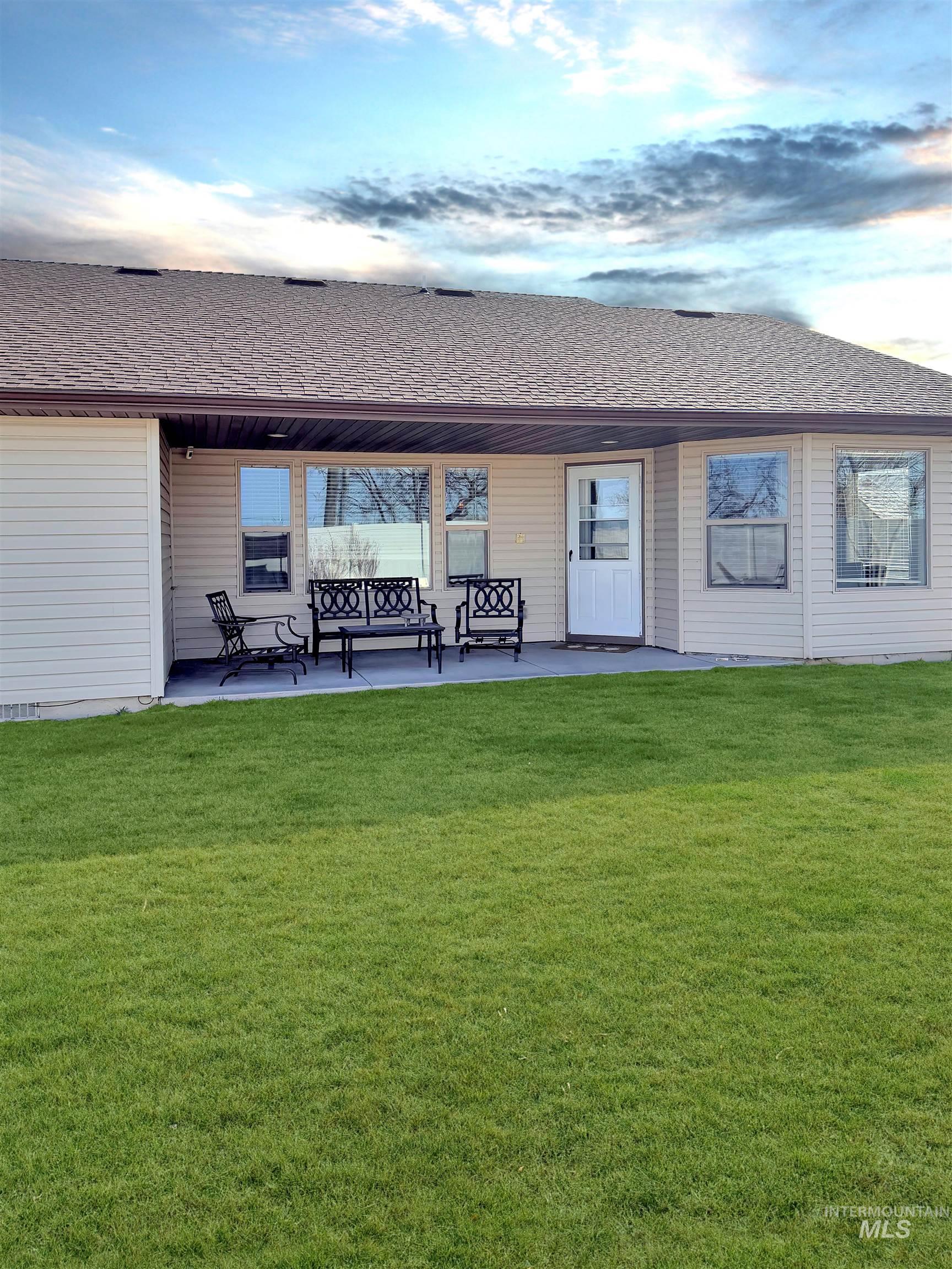 2407 Forge Street Twin Falls, ID 83301 - Photo 18 of 20 Back of property with roof with shingles, a yard, and a patio area