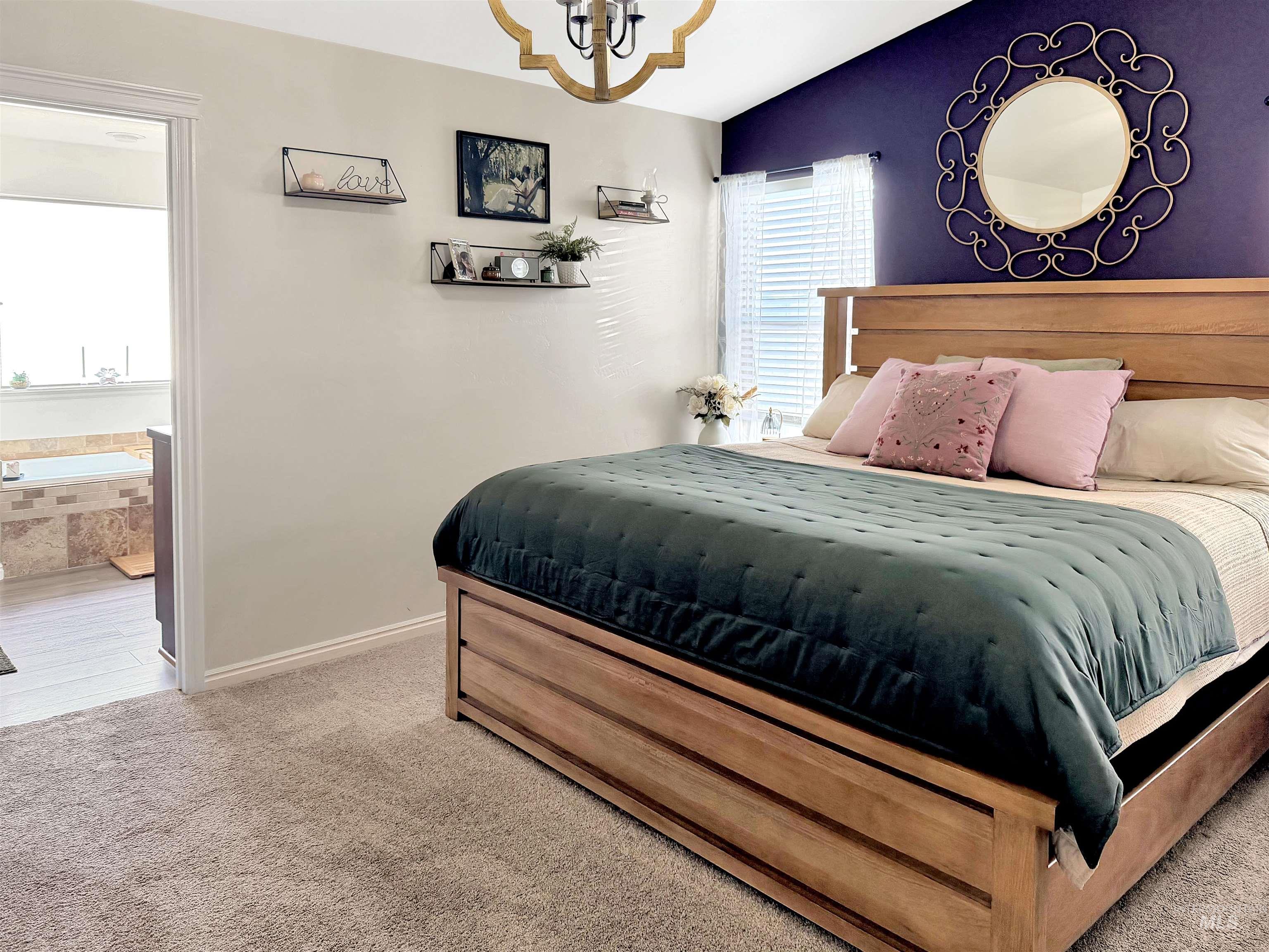 2407 Forge Street Twin Falls, ID 83301 - Photo 8 of 20 Bedroom with light colored carpet, ensuite bath, hanging lights, and vaulted ceiling
