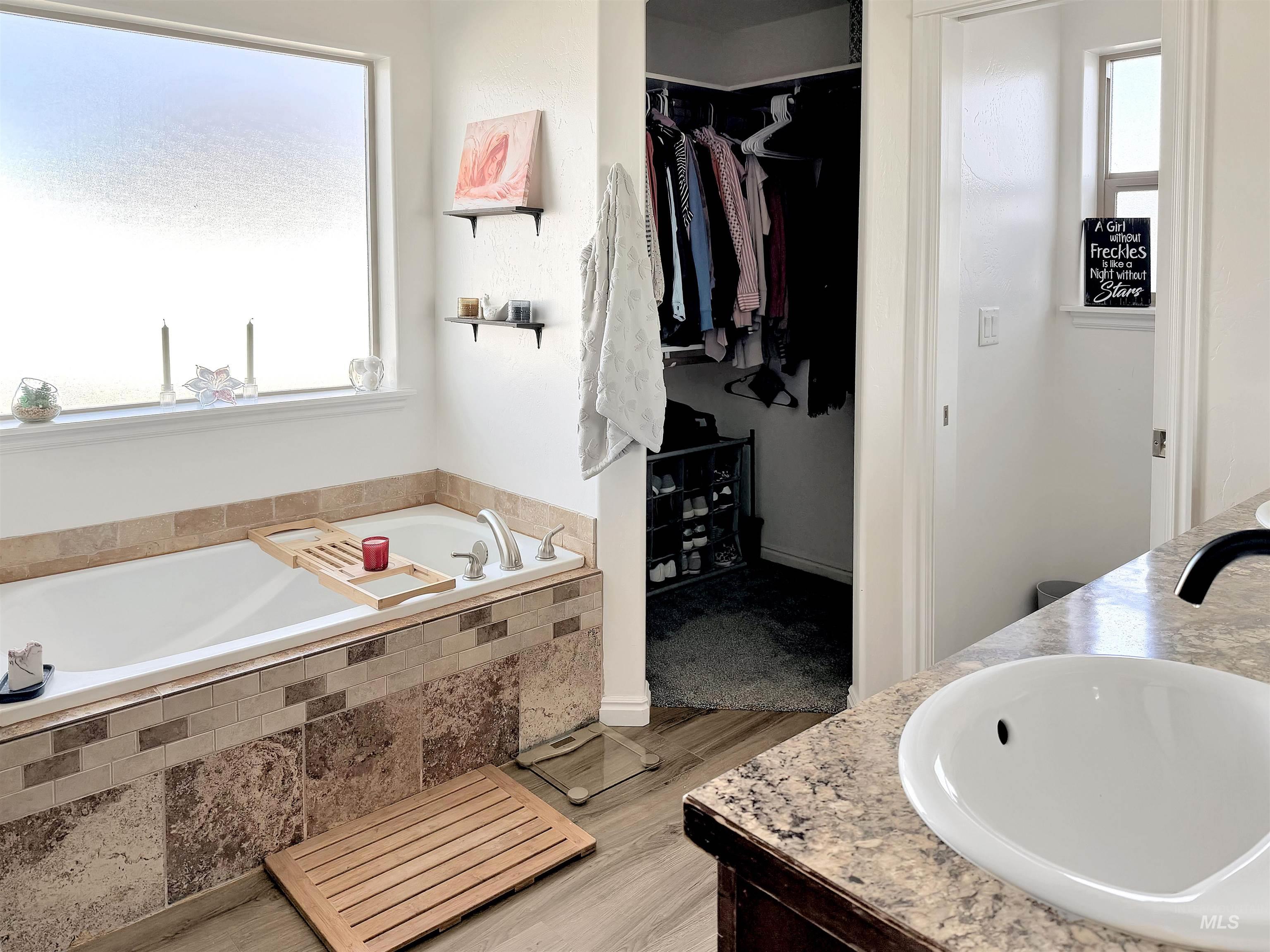 2407 Forge Street Twin Falls, ID 83301 - Photo 9 of 20 Full bath with double vanity, a walk in closet, and a garden tub