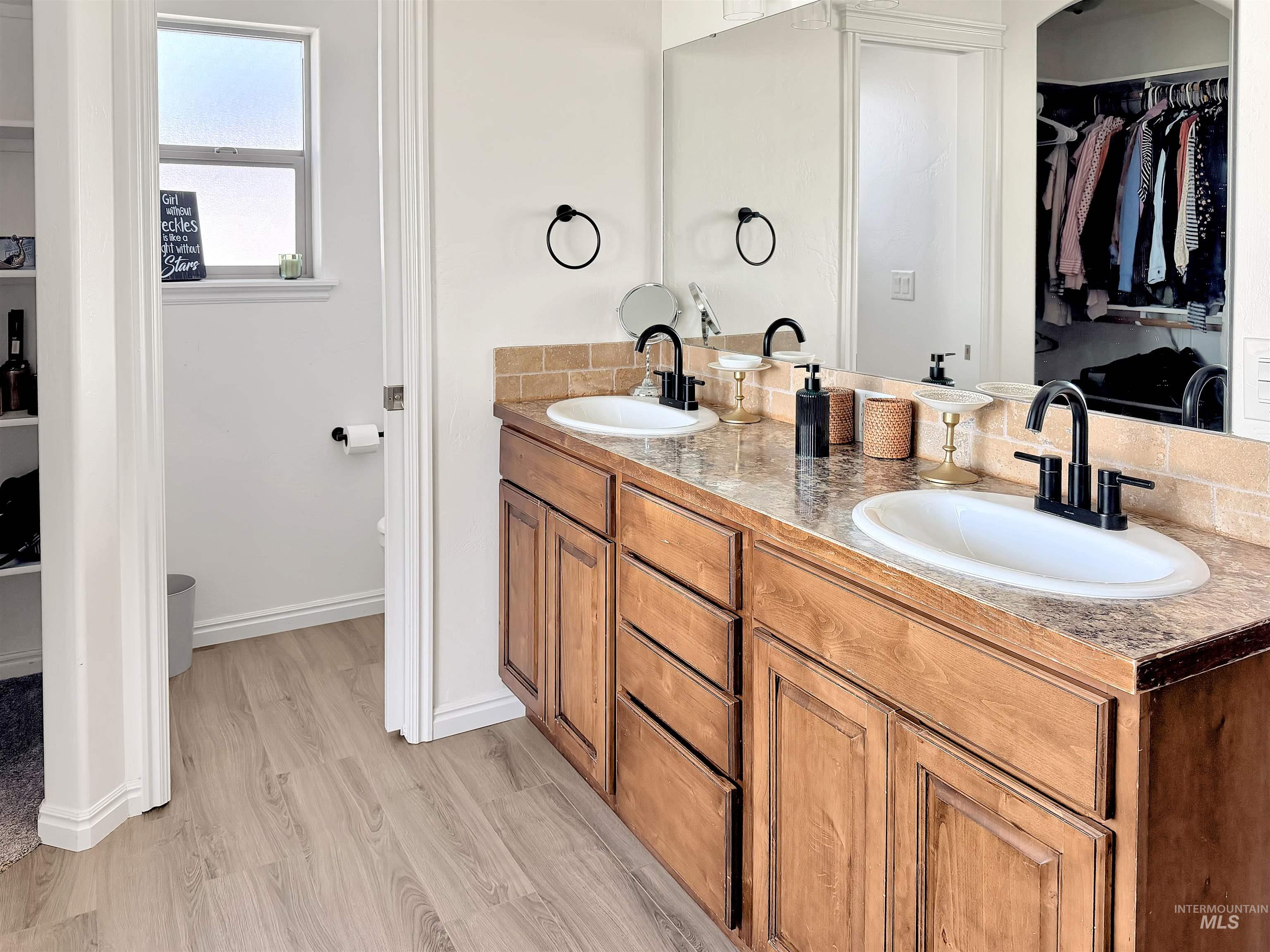 2407 Forge Street Twin Falls, ID 83301 - Photo 10 of 20 Bathroom featuring a walk in closet, double vanity, and light wood finished floors
