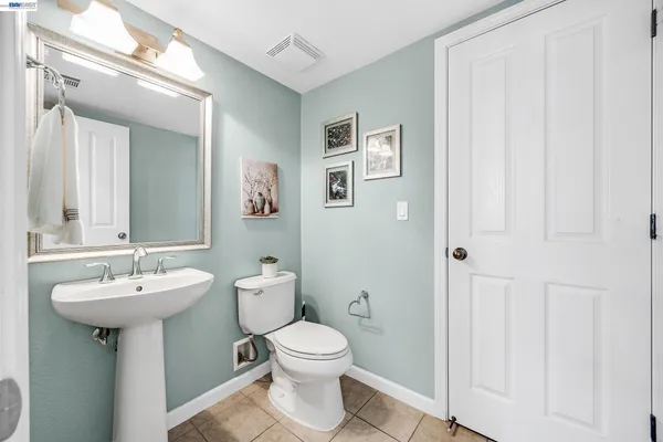 a bathroom with a sink toilet and mirror