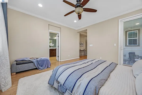 a bedroom with a bed and a ceiling fan