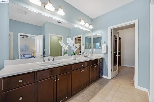 a spacious bathroom with a granite countertop sink and a mirror