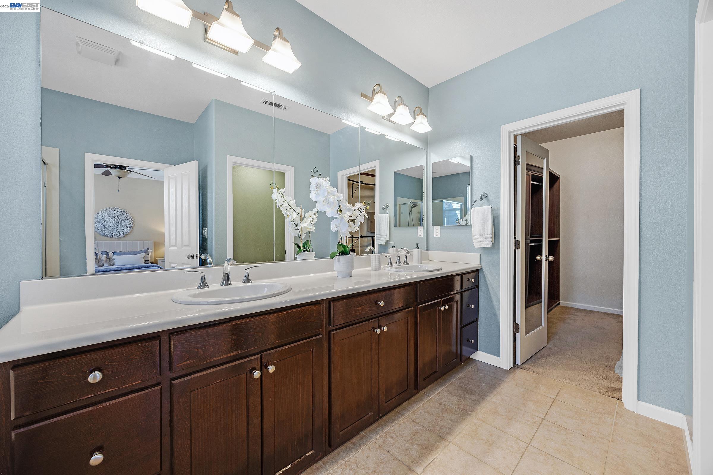 5216 Fioli Loop San Ramon, CA 94582 - Photo 15 of 41 a spacious bathroom with a granite countertop sink and a mirror