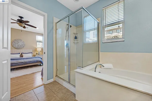 a bathroom with a tub sink and mirror