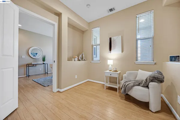 a living room with furniture and a wooden floor