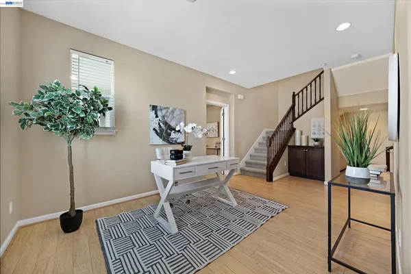 a living room with furniture and a potted plant