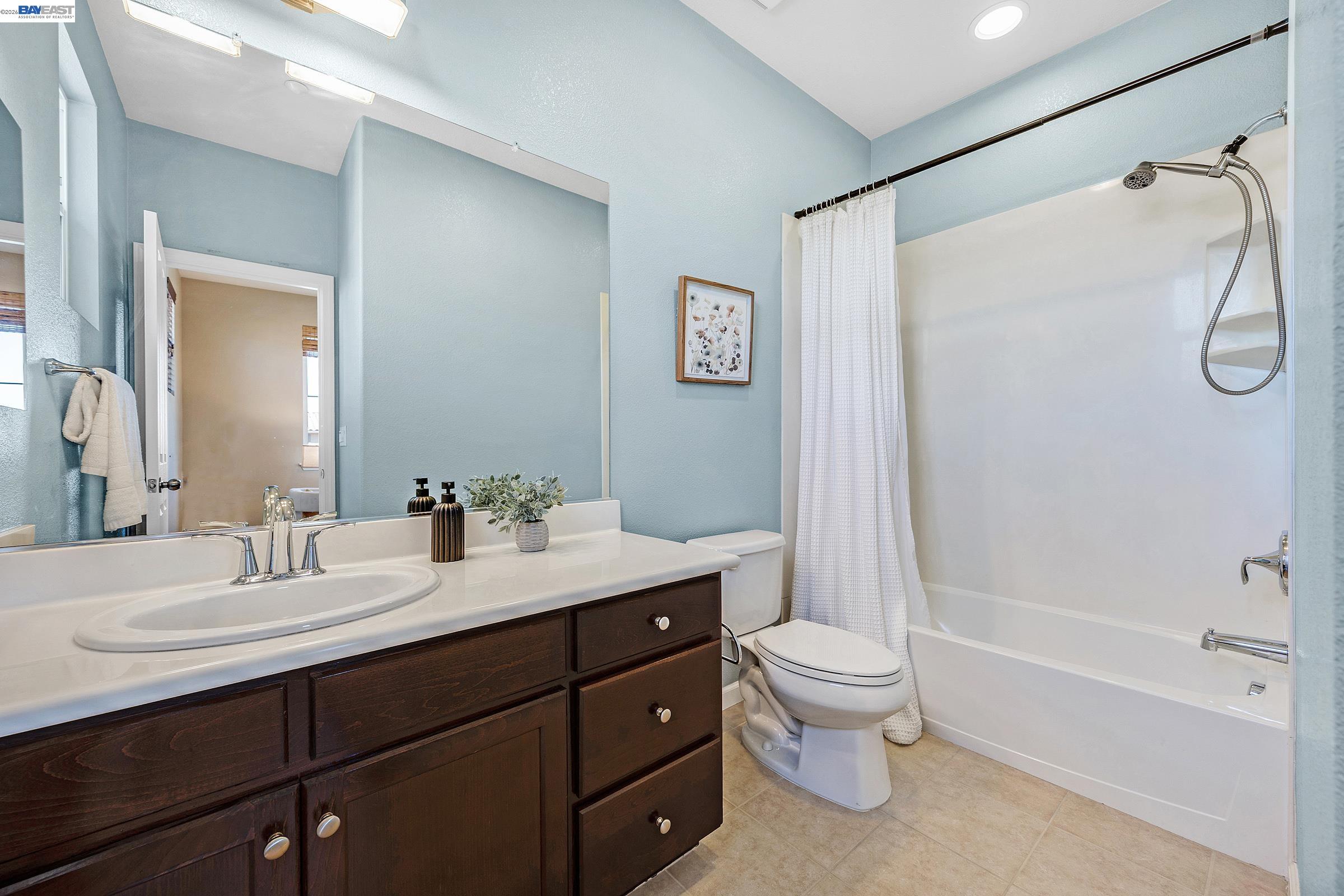 5216 Fioli Loop San Ramon, CA 94582 - Photo 29 of 41 a bathroom with a double vanity sink toilet mirror and shower
