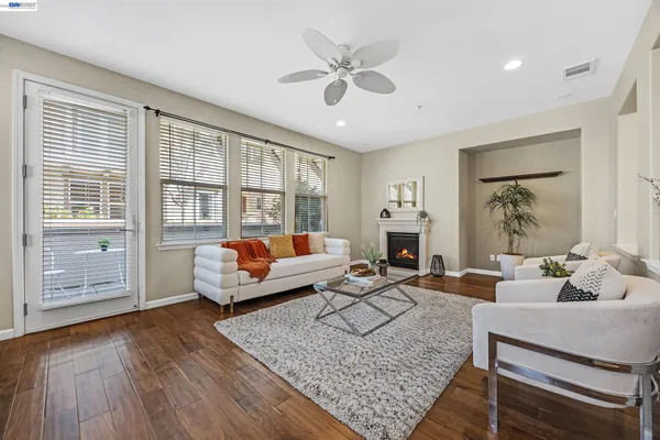 a living room with fireplace furniture and a window
