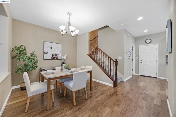 a view of a dining room with furniture wooden floor and a chandelier