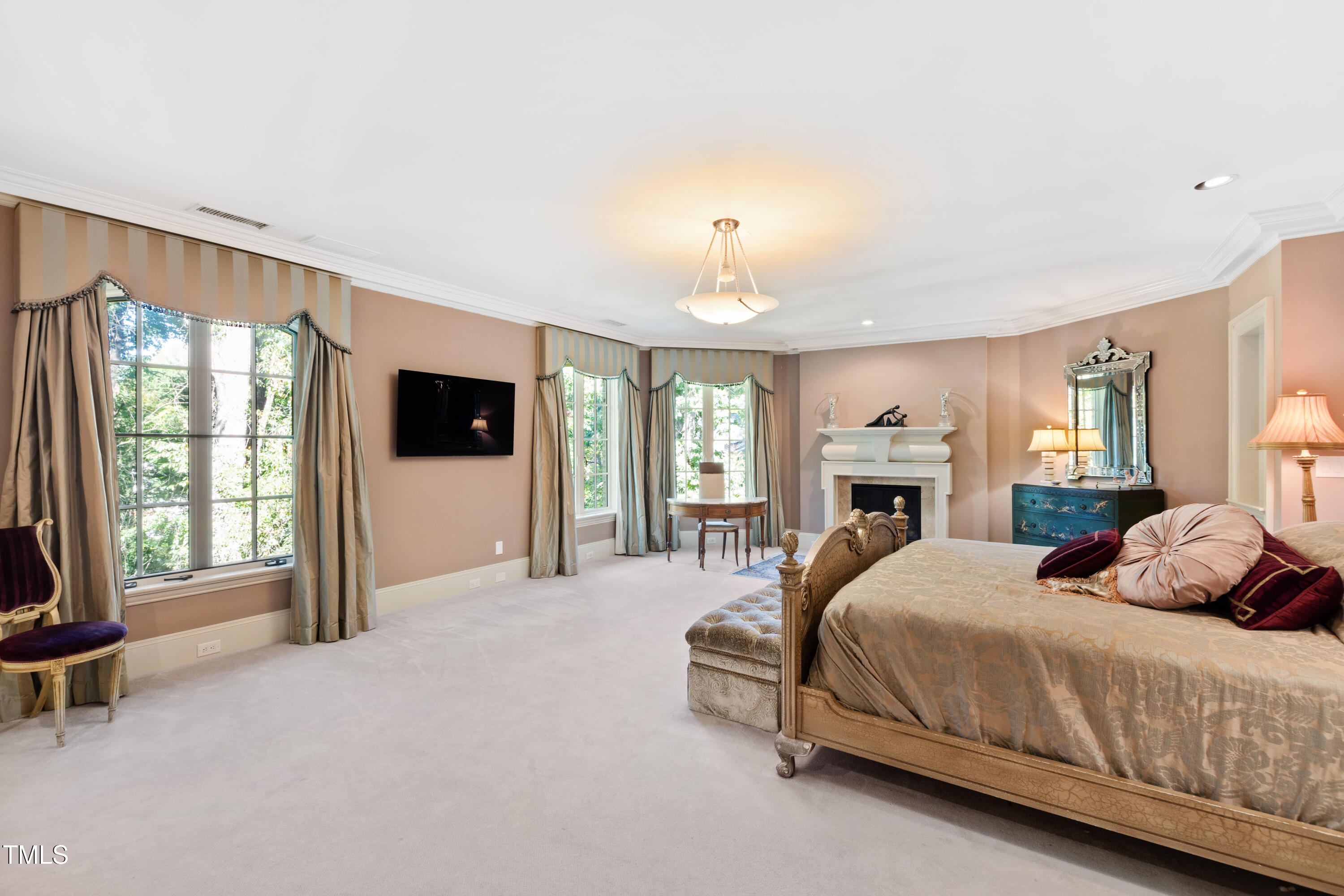 2658 Davis Street Raleigh, NC 27608 - Photo 53 of 99 a spacious bedroom with a large bed and a tv