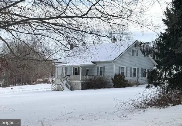 a front view of house with yard and trees around