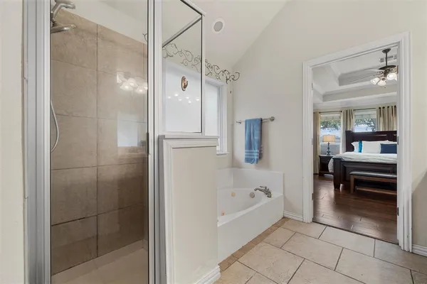 a bathroom with a bathtub and a shower