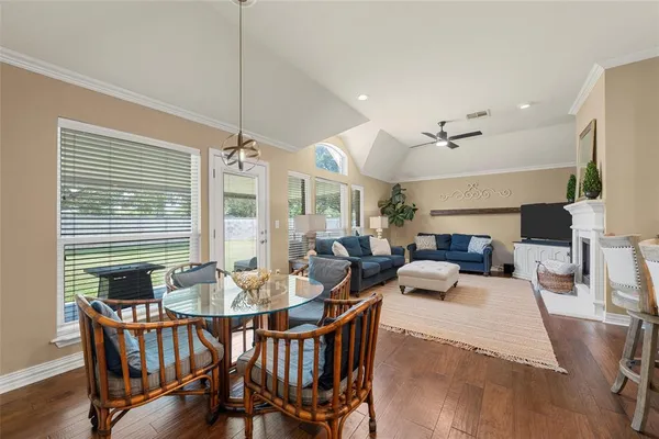 a living room with fireplace furniture and a chandelier