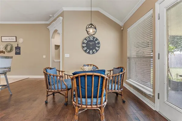 a view of a dining room with furniture wooden floor and front door