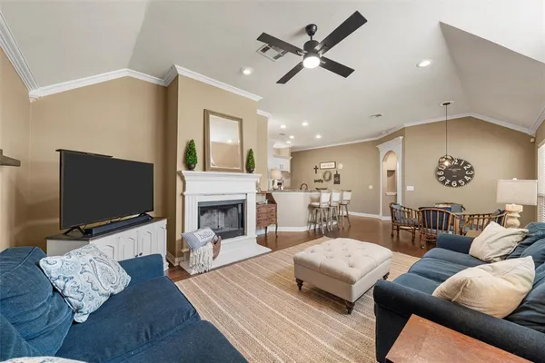 a living room with furniture fireplace and flat screen tv
