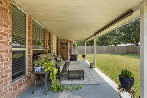 a view of a chair and tables in the patio