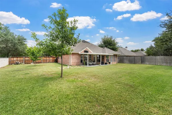 a house with green field in front of it