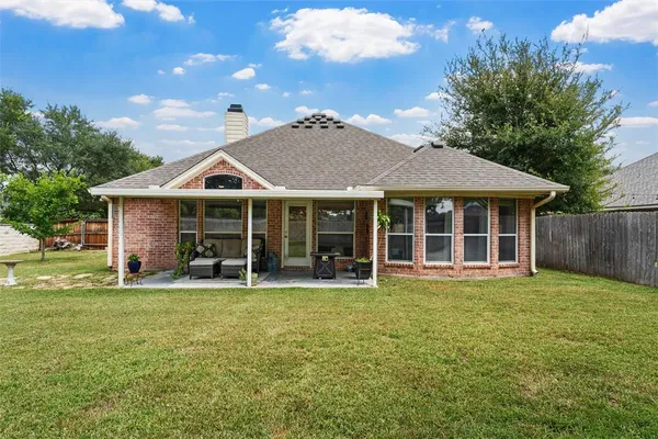 a view of a house with a yard and sitting area