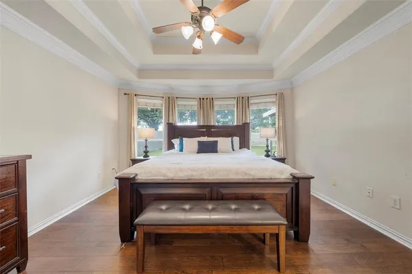 a bedroom with a bed window and a chandelier