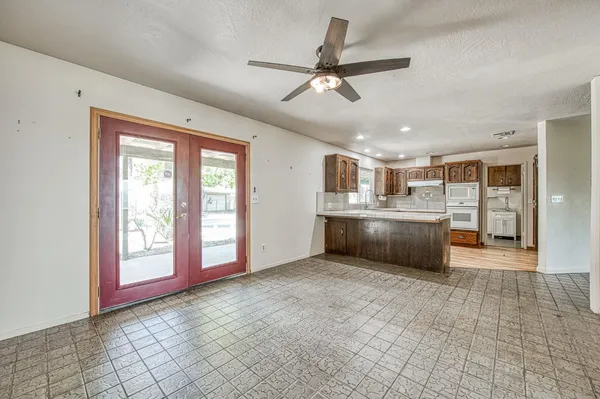 an empty room with windows and closet