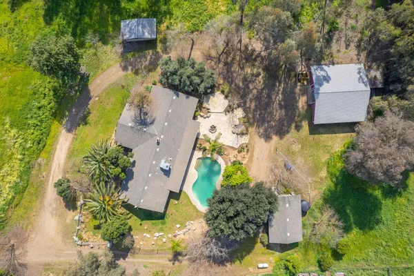 an aerial view of residential houses with yard