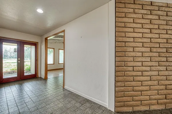 a view of a livingroom with wooden floor and a fireplace