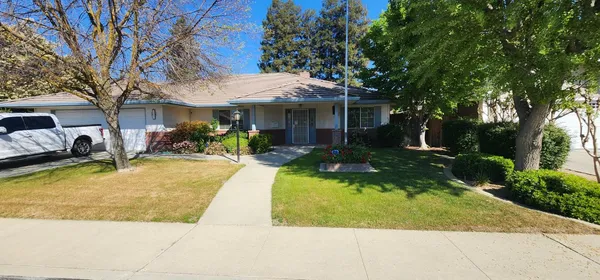 a view of a house with swimming pool and sitting area