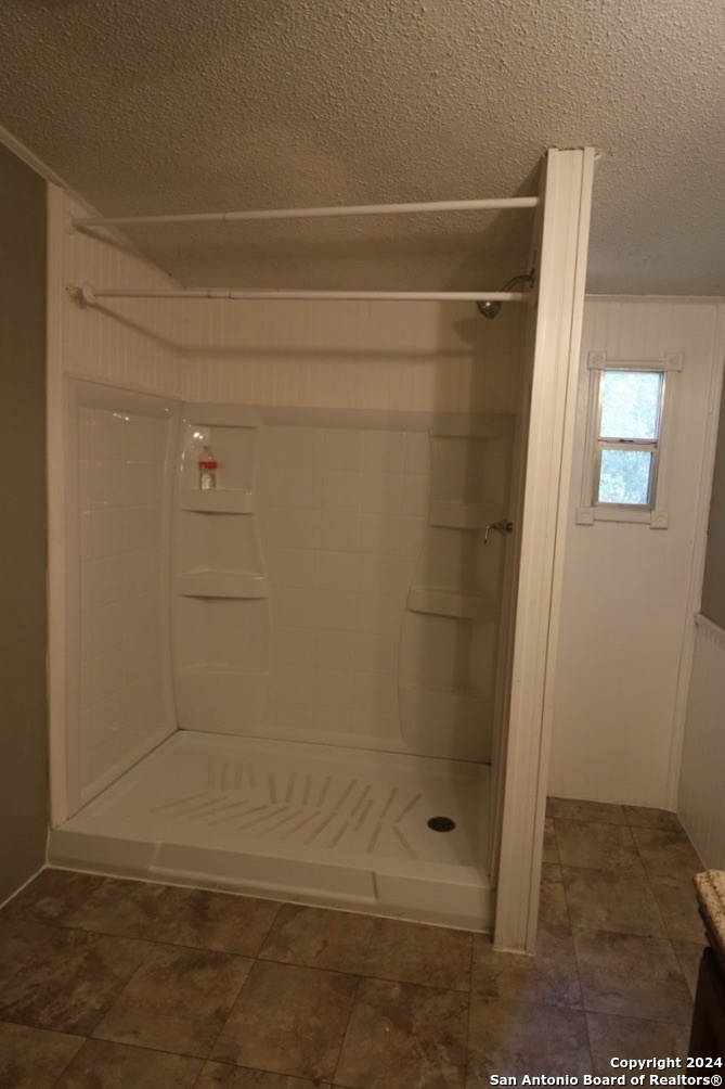 454 Overland Trail Bandera, TX 78003 - Photo 11 of 24 a bathroom with a glass shower door