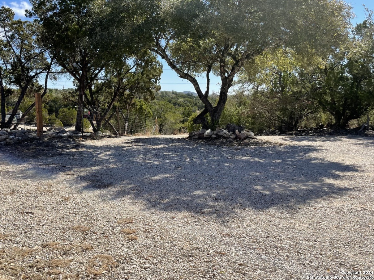 454 Overland Trail Bandera, TX 78003 - Photo 17 of 24 a view of a yard with a tree