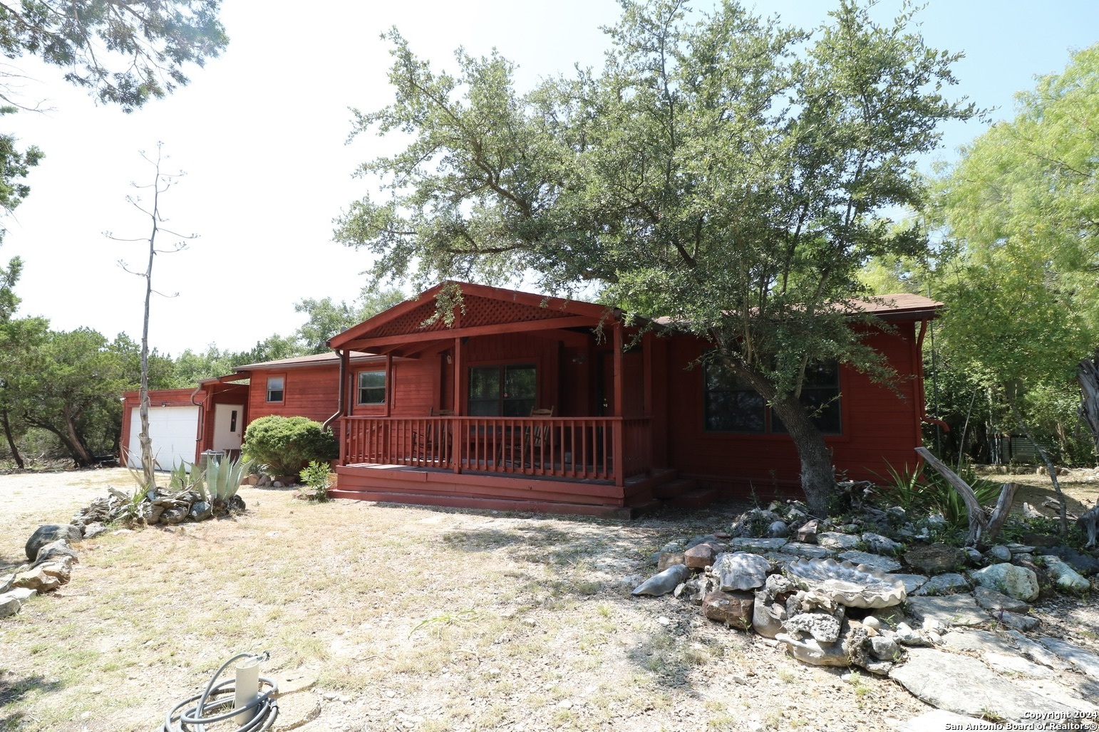 454 Overland Trail Bandera, TX 78003 - Photo 2 of 24 a front view of a house with a yard