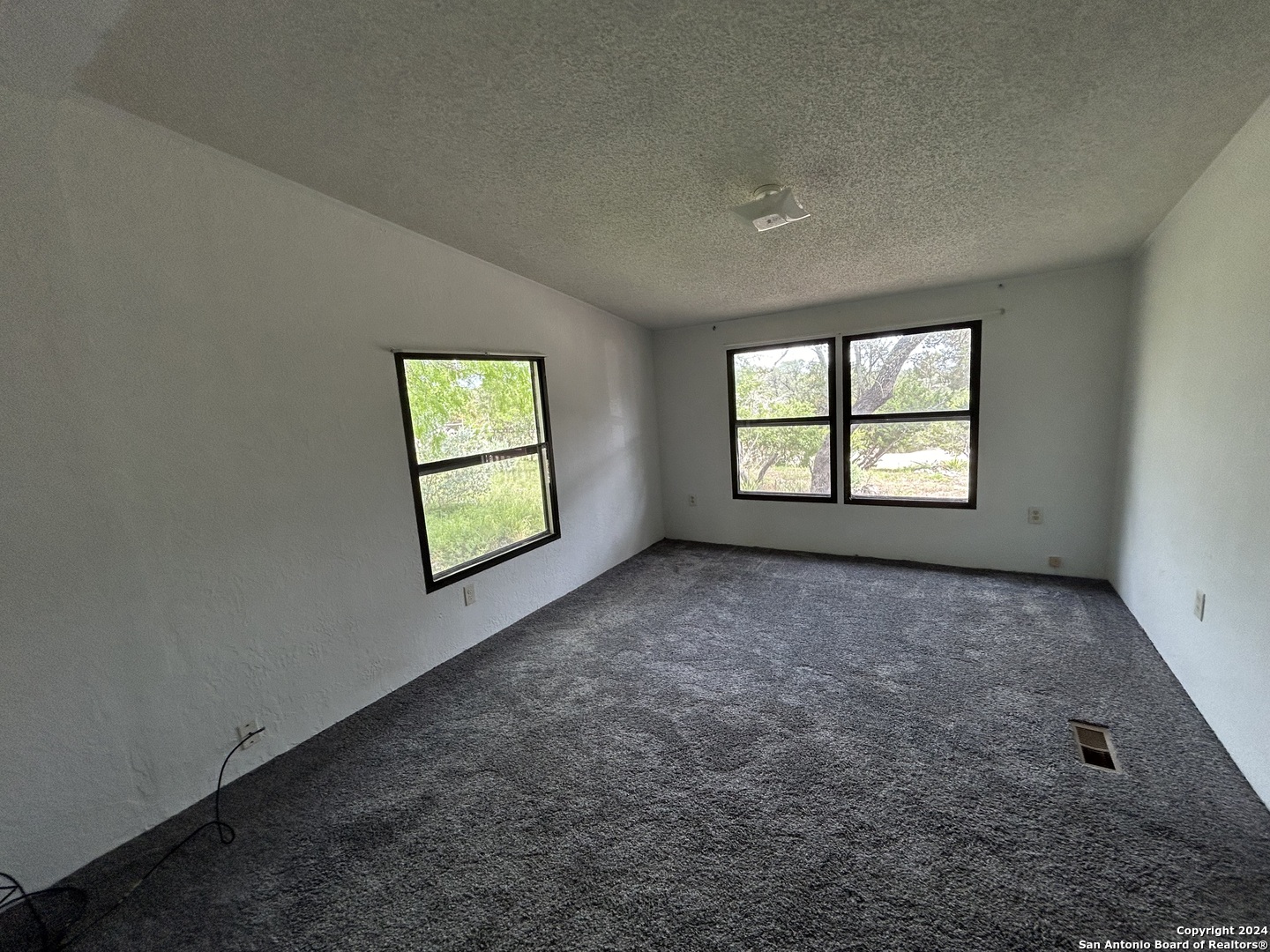 454 Overland Trail Bandera, TX 78003 - Photo 10 of 24 an empty room with windows