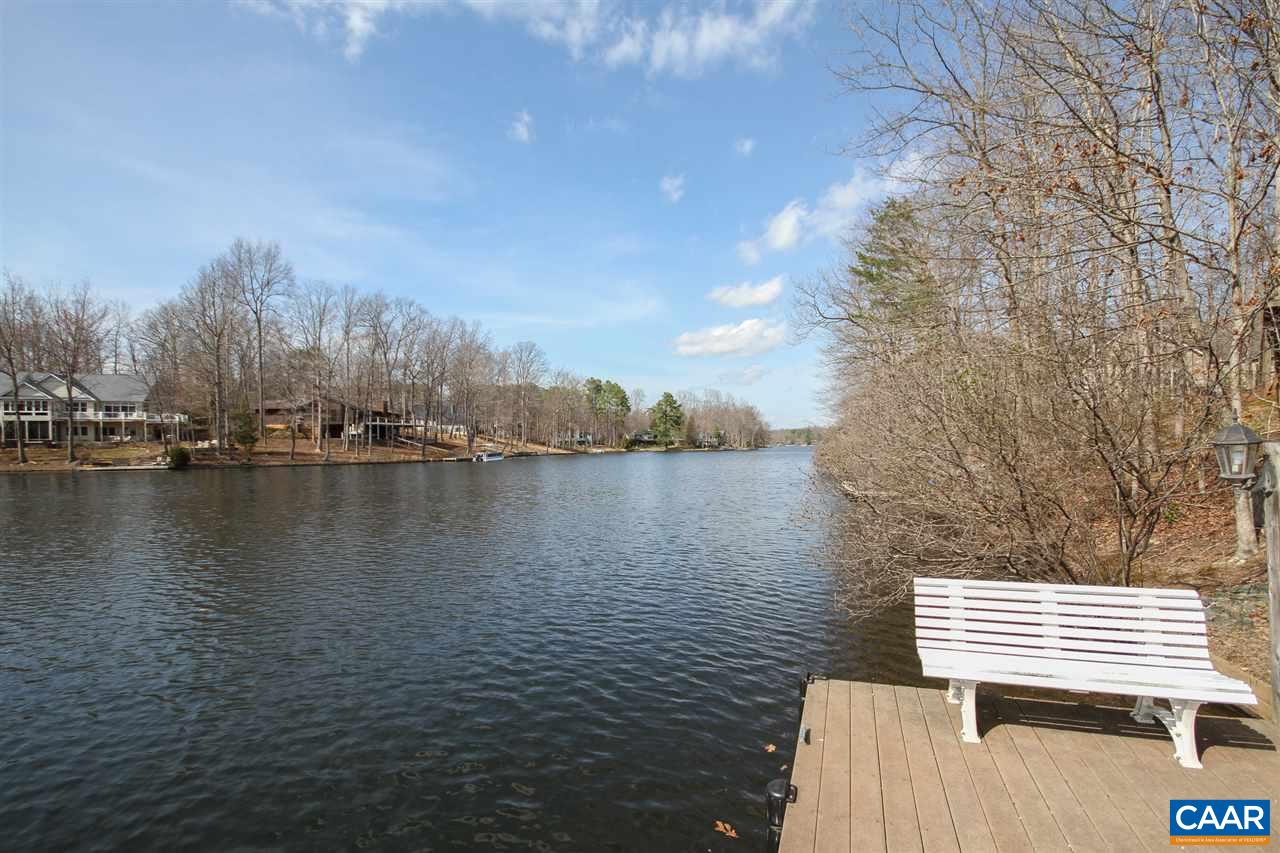 60 Dogleg Road Palmyra, VA 22963 - Photo 35 of 35 a view of a lake with chairs and wooden fence