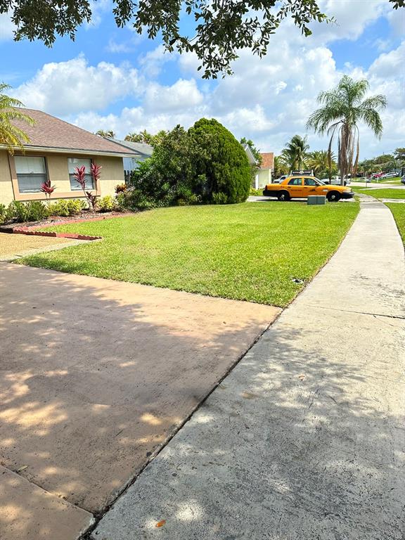 9138 Bedford Drive Boca Raton, FL 33434 - Photo 3 of 21 a view of a swimming pool and front of house