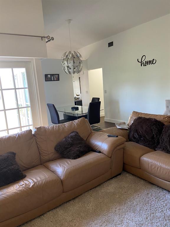 9138 Bedford Drive Boca Raton, FL 33434 - Photo 4 of 21 a living room with furniture chandelier and a window