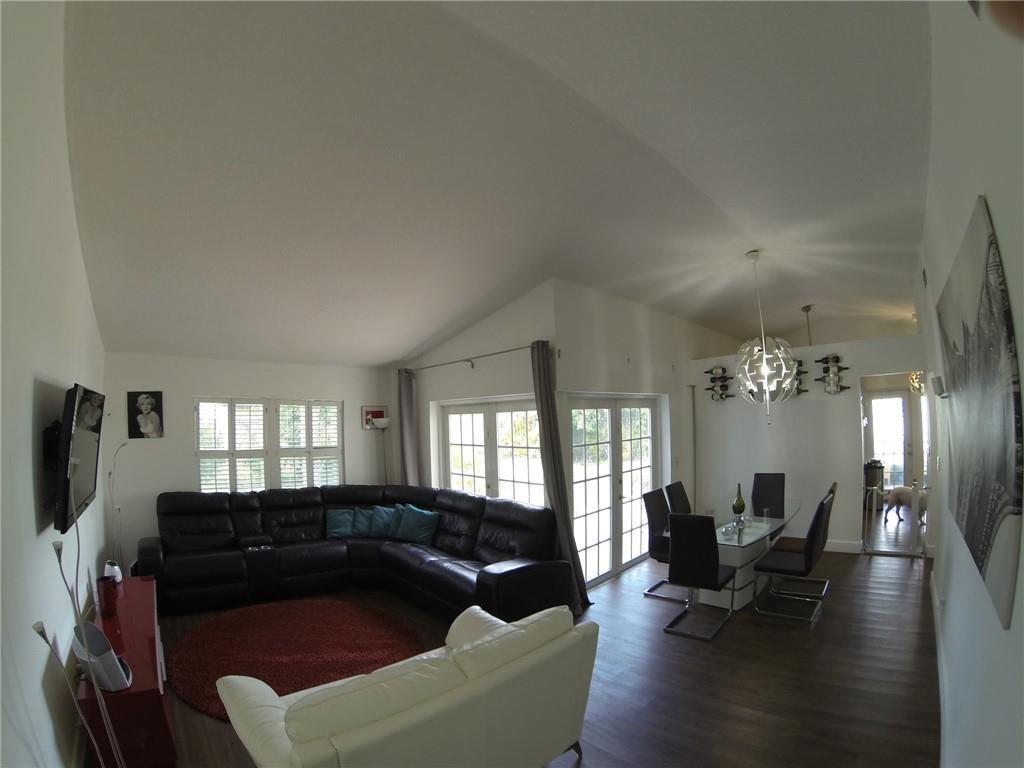 9138 Bedford Drive Boca Raton, FL 33434 - Photo 5 of 21 a living room with furniture and a flat screen tv