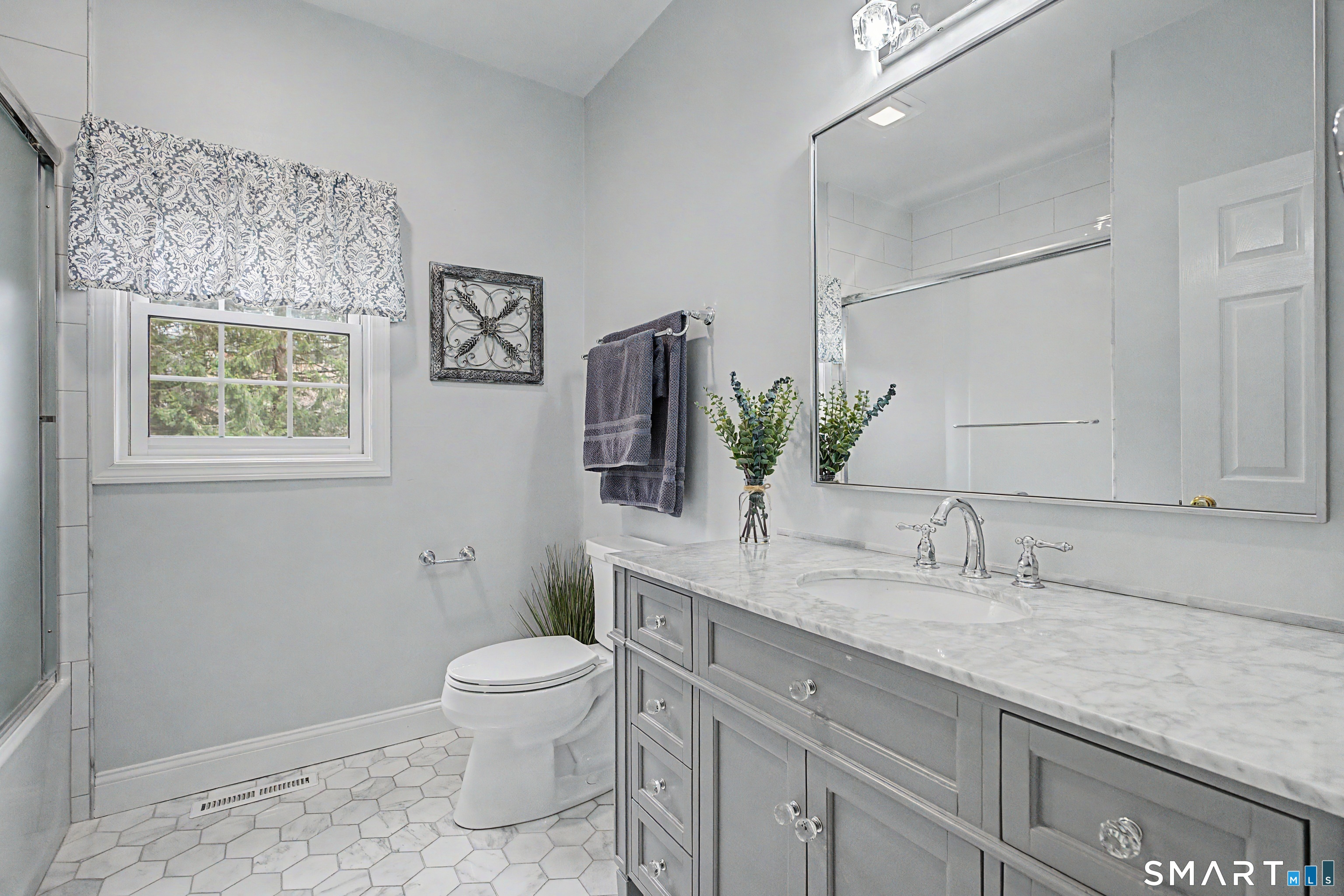 445 Dublin Road Southbury, CT 06488 - Photo 17 of 40 a bathroom with a granite countertop sink a toilet and mirror
