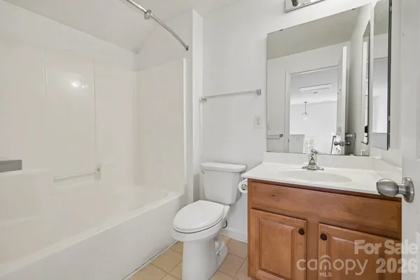 a bathroom with a sink toilet vanity and shower