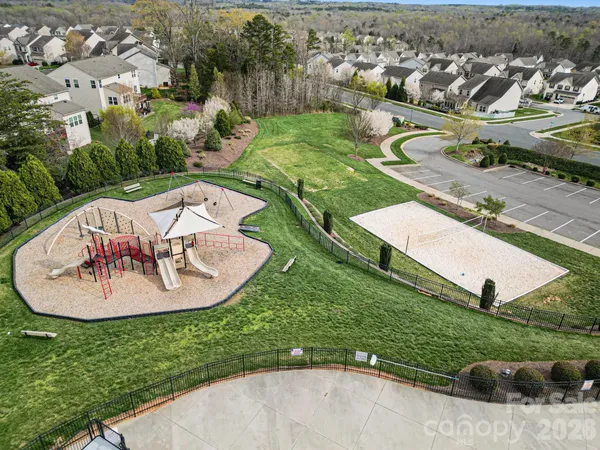 an aerial view of a house with outdoor space and swimming pool
