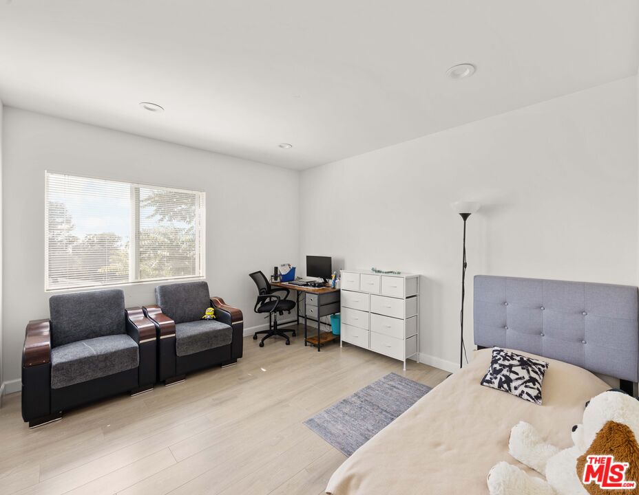7752 Le Berthon Street Tujunga, CA 91042 - Photo 12 of 15 a bedroom with furniture and a large window