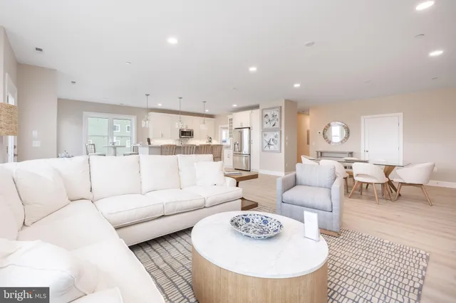 a living room with furniture potted plant and white walls